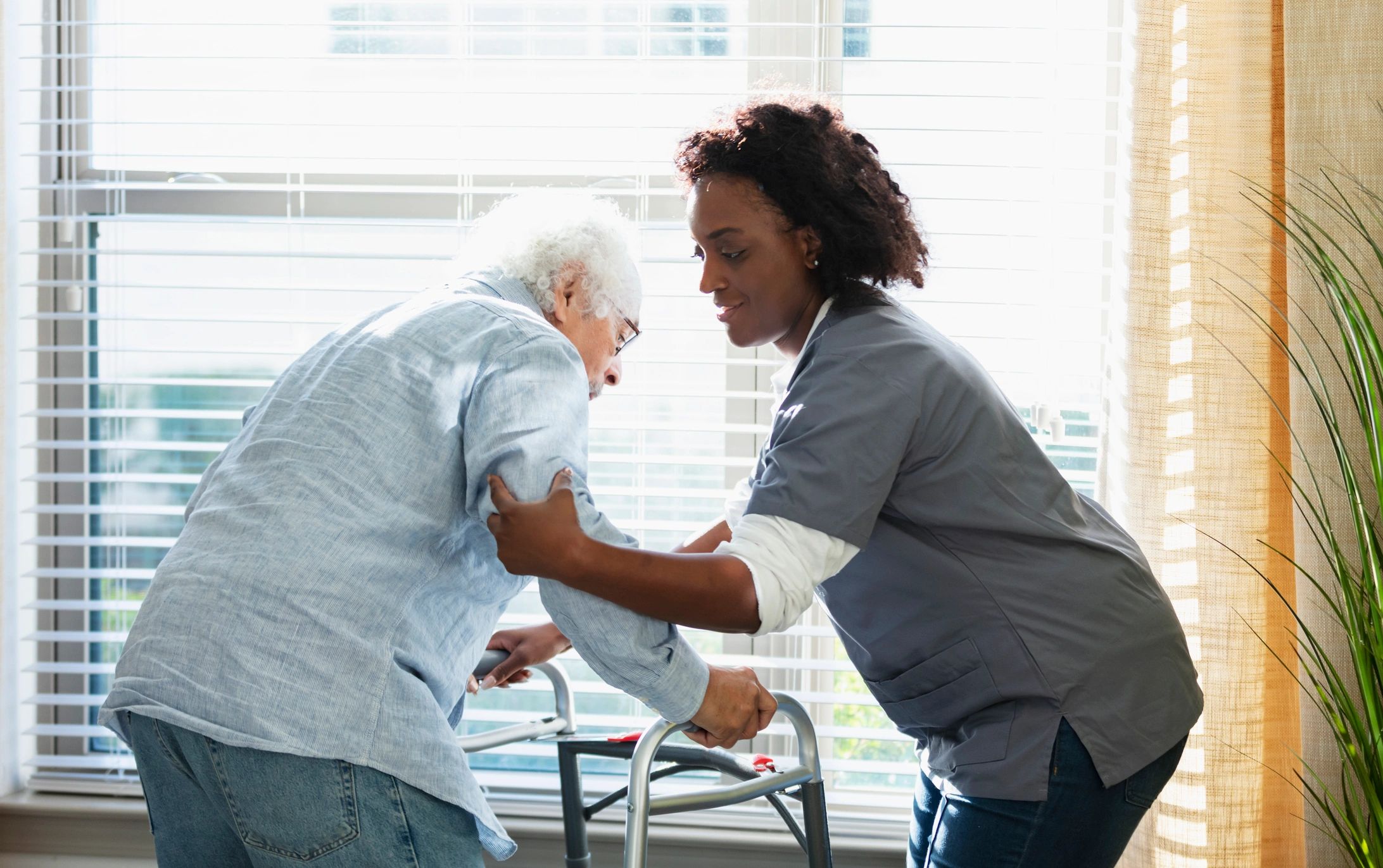 Home healthcare worker assisting a senior at home