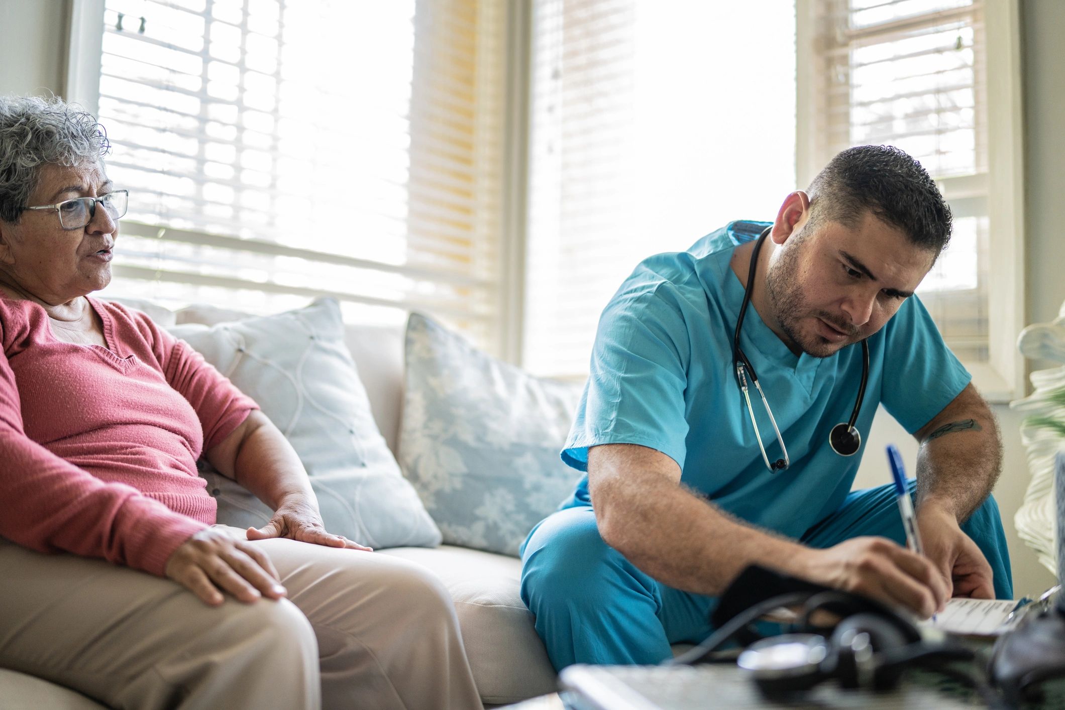 Nurse speaking with a client during an in-home care visit